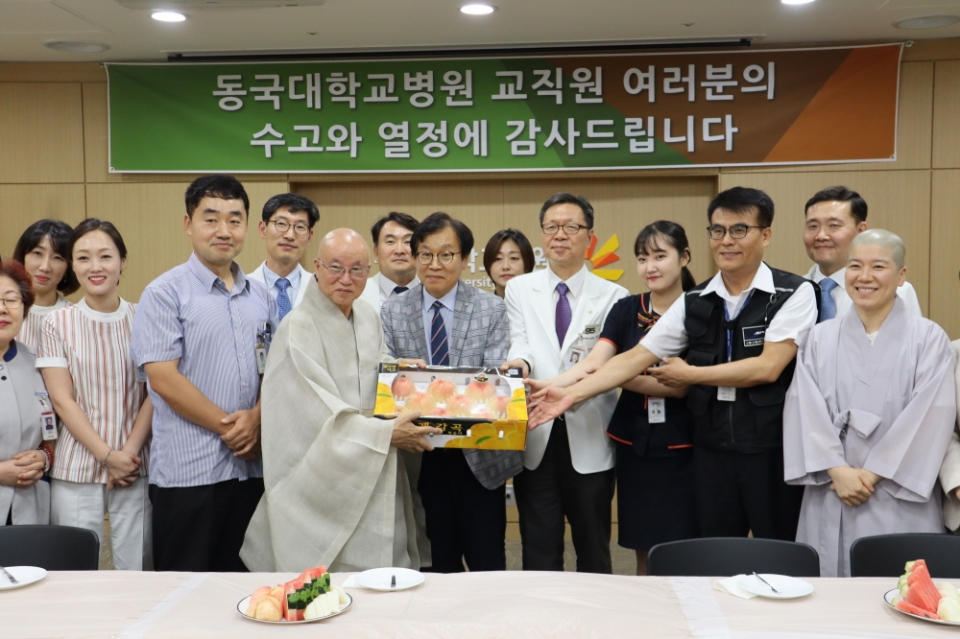 학교법인 동국대학교 이사장 법산스님이 일산병원 교직원들에게 과일을 선물하는 모습.
