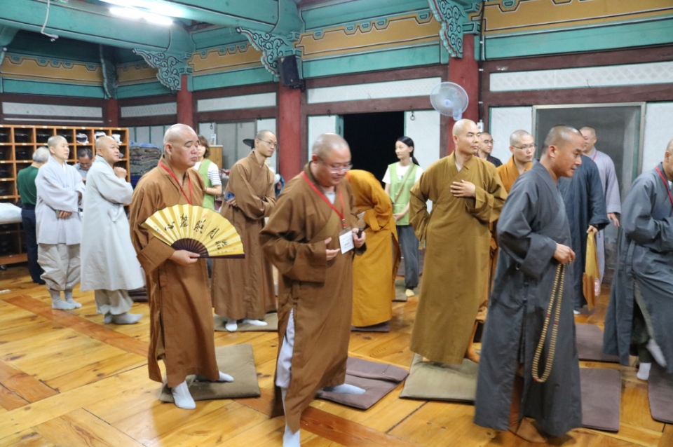 콘서트가 끝나고 중국 스님들이 중국식 승복을 입고 일어서서 자리 정돈을 하고 있다.