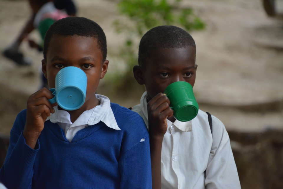 해피 콘 사업으로 제공하는 영양 죽이 옥수수 가루에 설탕과 마가린을 넣어 더 고소해 졌다. 영양 죽을 먹는 무와송가 초등학교 아이들.
