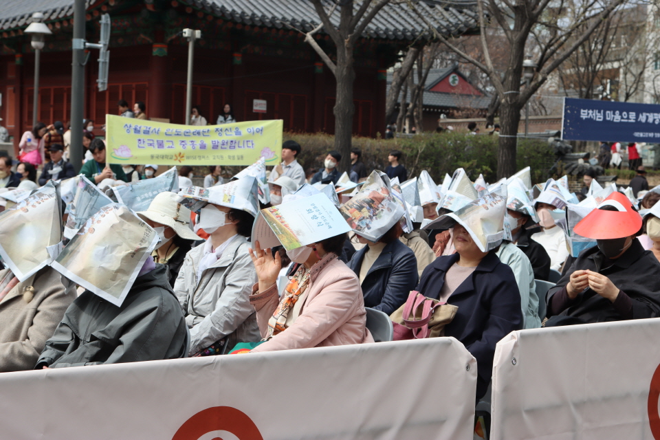 강한 햇빛이 내리쬐고 있지만 자리를 지키고 있는 신도들.