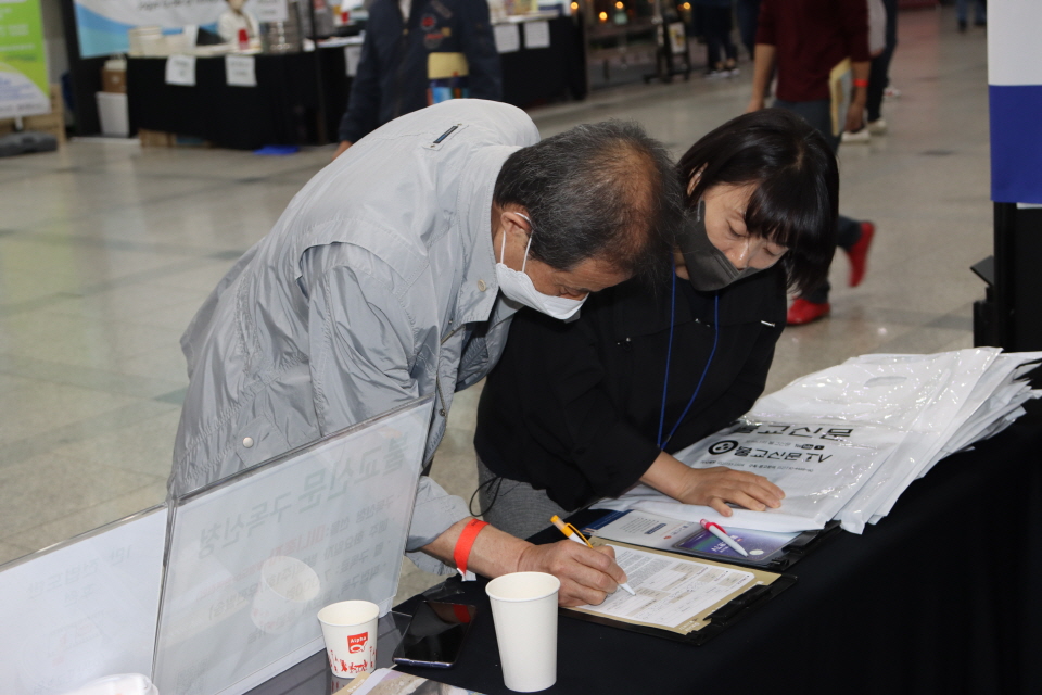 불교신문 홍보부스에서 한 불자가 구독신청을 하고 있다.